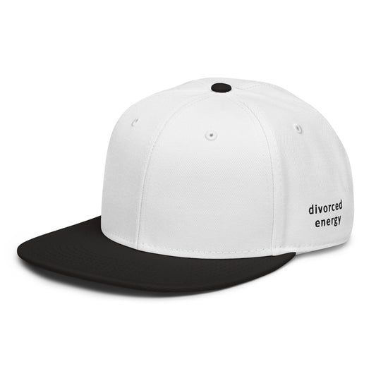 Side view of black and white snapback showing flat brim with Divorced Energy  embroidered in black