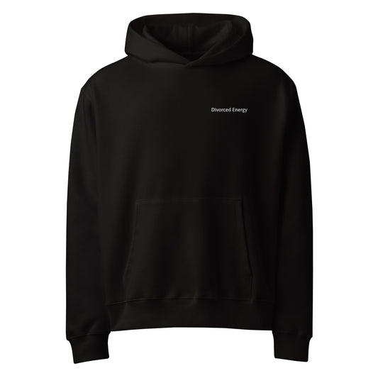 Front view of black pullover hoodie with hood and kangaroo pocket and divorced energy embroidered in white on left chest 