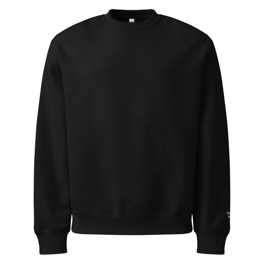 Front view of black crewneck sweatshirt with Divorced Energy embroidered in white on left wrist